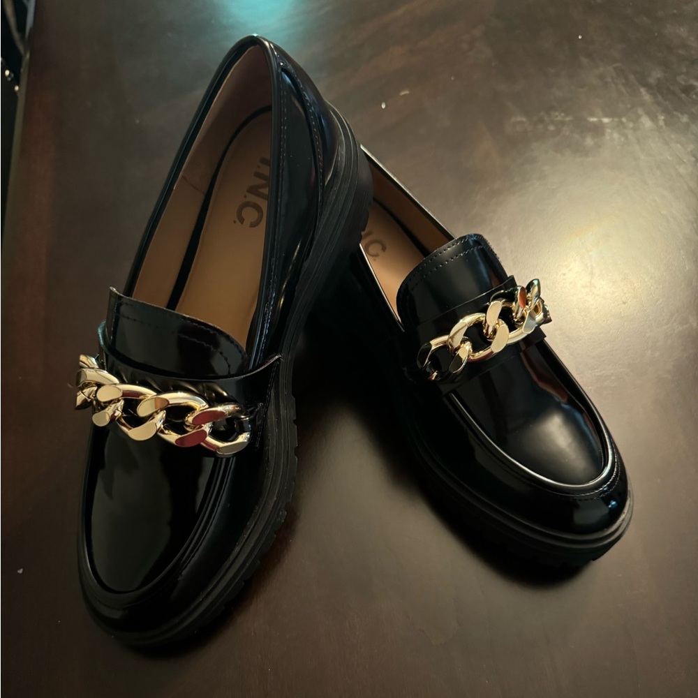 Brand new, never worn. Black patent loafers with gold detail.